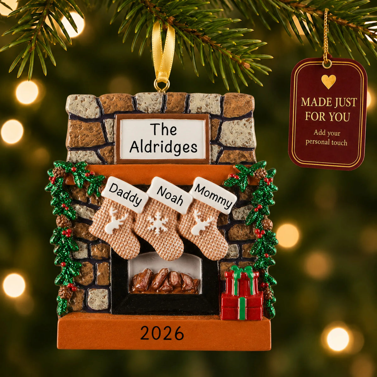 Rustic fireplace family of 3 christmas ornament hanging on a lit Christmas tree with a Made Just For You gift tag