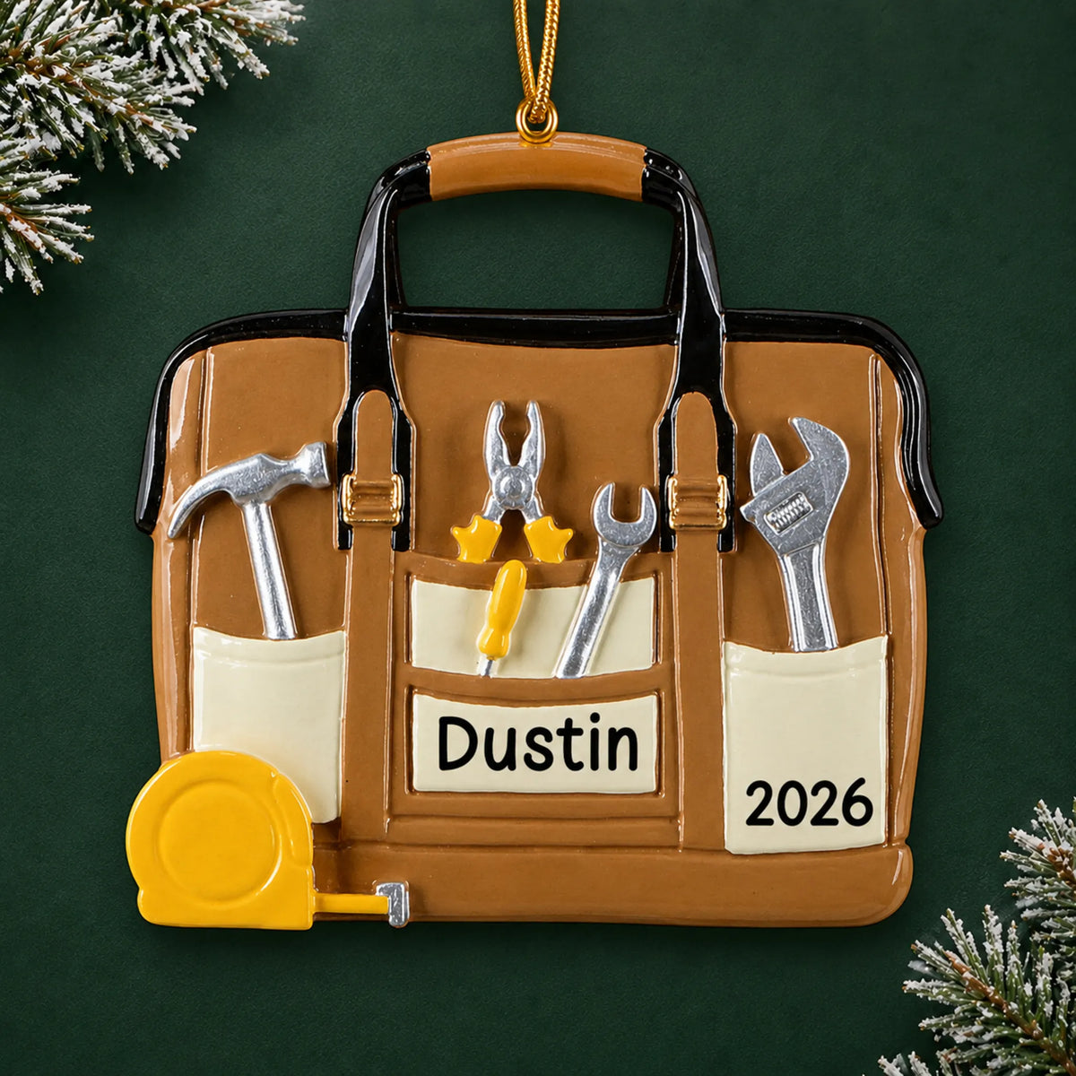 Personalized tool bag handyman christmas ornament on a dark green pine background