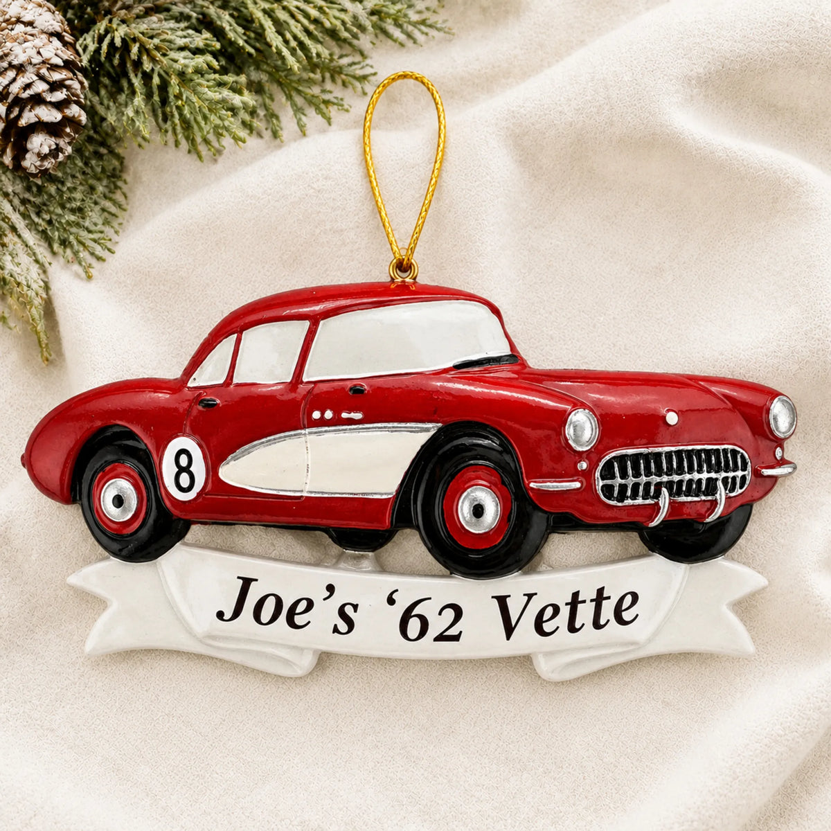 Personalized Classic Car christmas ornament laid on a soft white knit blanket