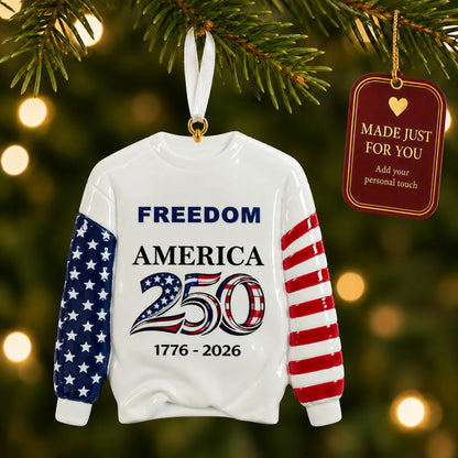 Personalized America 250 sweatshirt Christmas ornament hanging among tree lights with a Made Just For You tag
