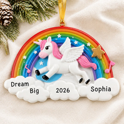 Personalized rainbow unicorn sparkles christmas ornament laid on a soft white knit blanket