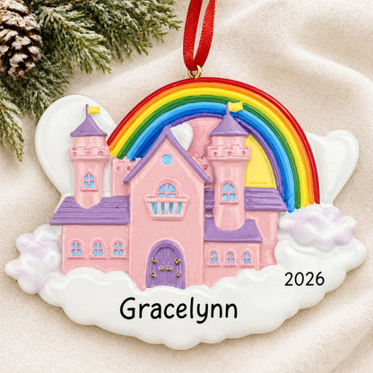 Personalized princess castle magical rainbow christmas ornament laid on a soft white knit blanket