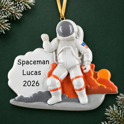 Personalized astronaut christmas ornament on a dark green pine background