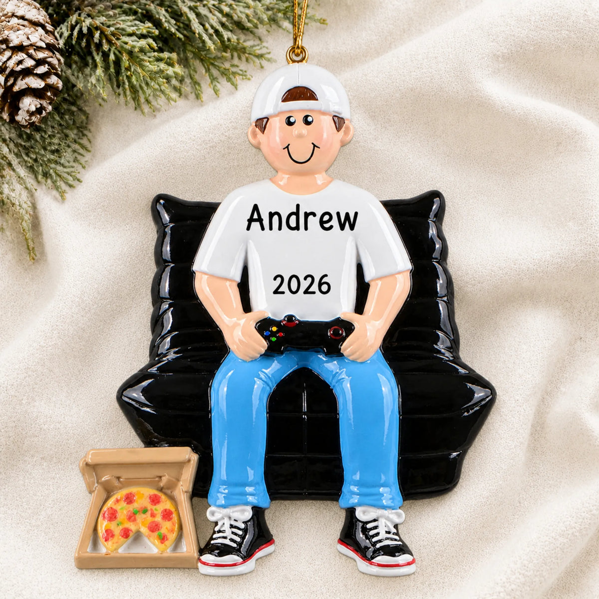 Personalized gamer boy christmas ornament laid on a soft white knit blanket
