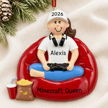 Personalized gamer girl christmas ornament laid on a soft white knit blanket
