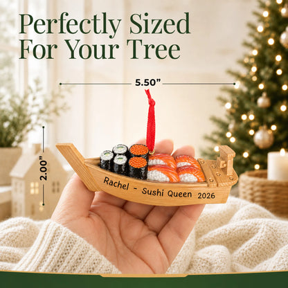 Size guide: the personalized Sushi Boat christmas ornament is 5.50 in wide by 2.00 in tall, shown in hand