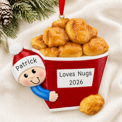 Personalized Chicken Nuggets christmas ornament laid on a soft white knit blanket