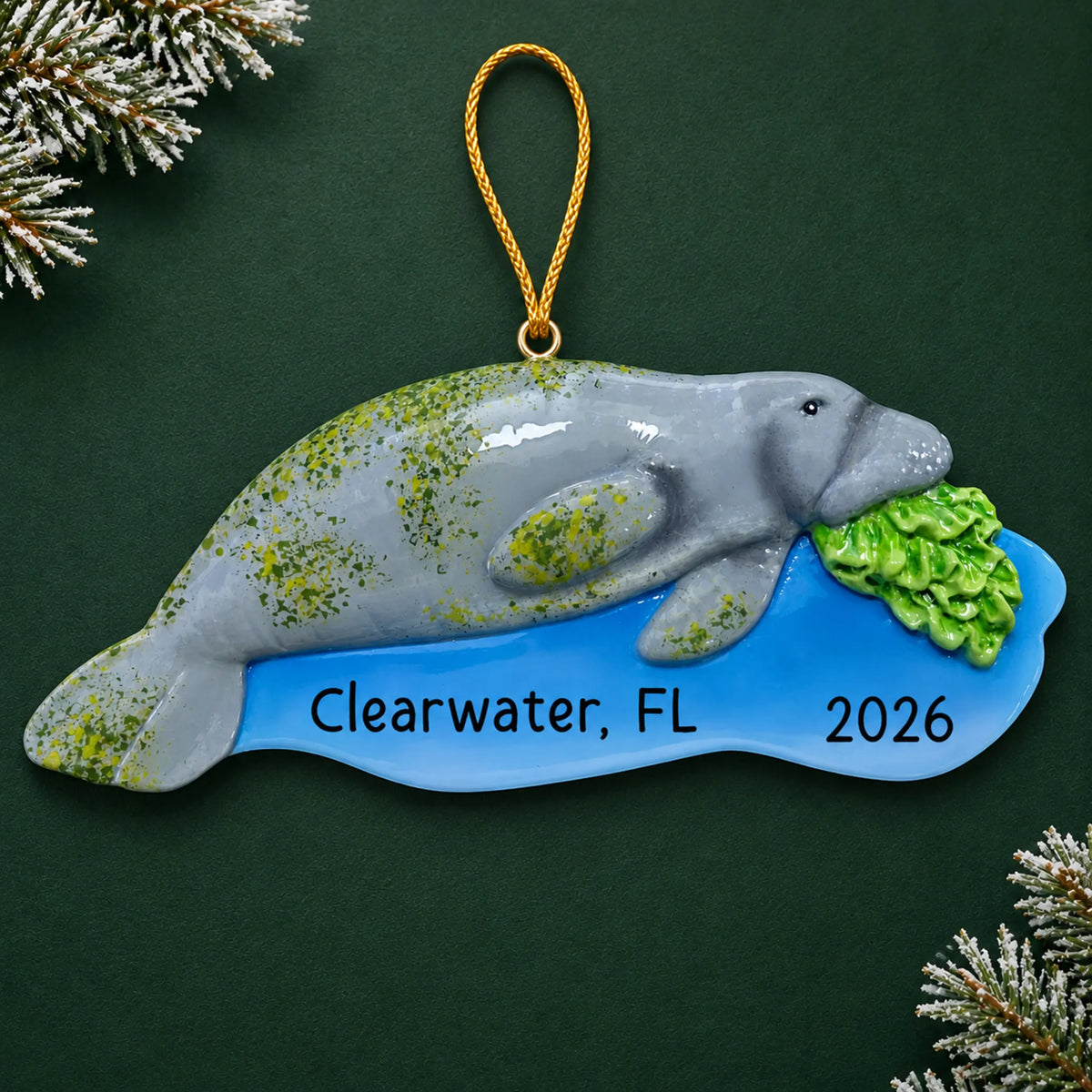 Personalized manatee christmas ornament on a dark green pine background