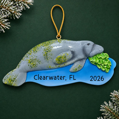 Personalized manatee christmas ornament on a dark green pine background