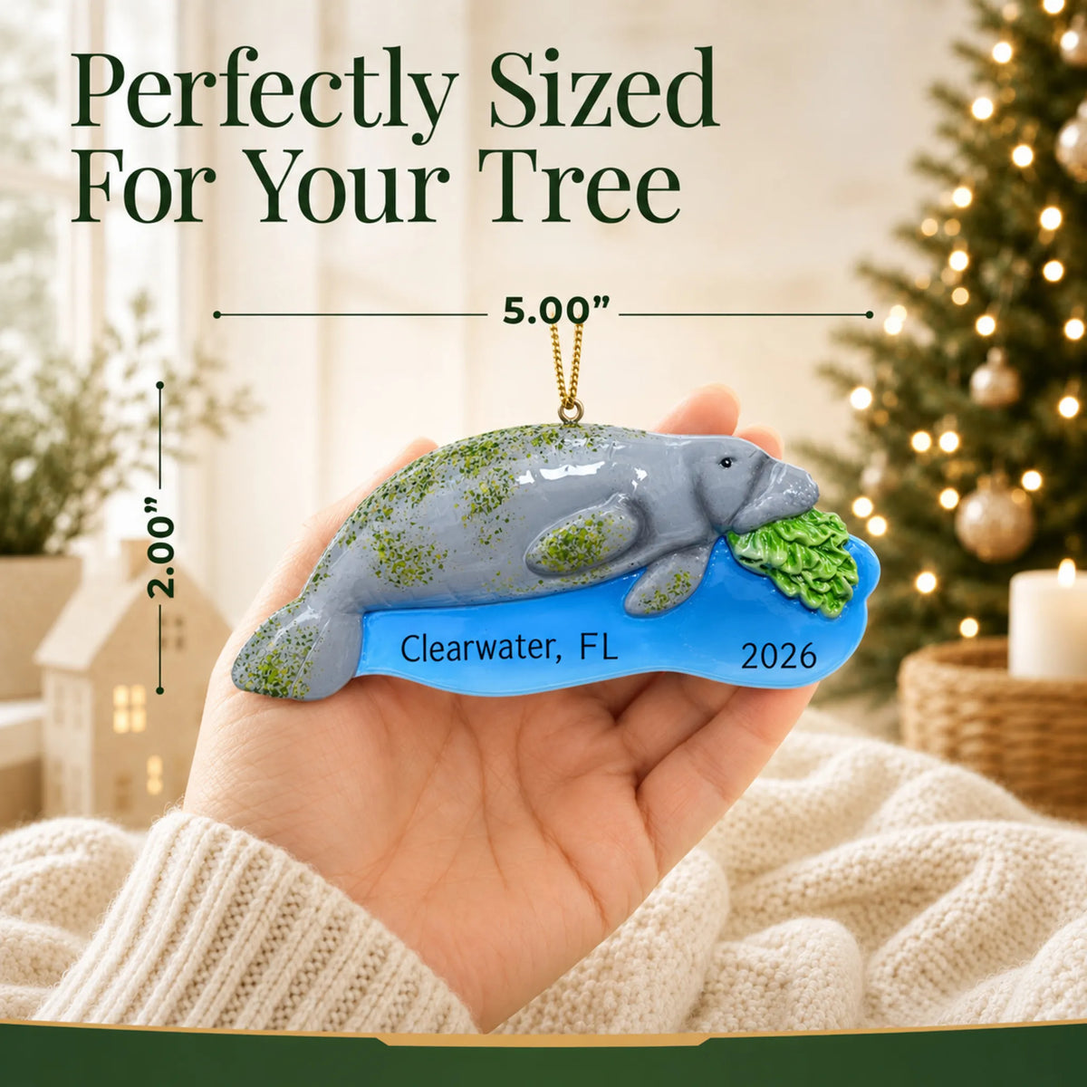 Size guide: the personalized manatee christmas ornament is 5.00 in wide by 2.00 in tall, shown in hand