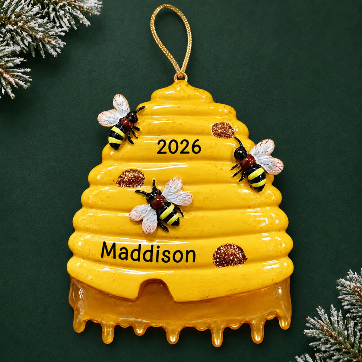Personalized honey beehive christmas ornament on a dark green pine background