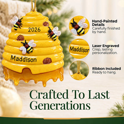Hand-painted details and laser engraved personalization on the honey beehive christmas ornament, ribbon included