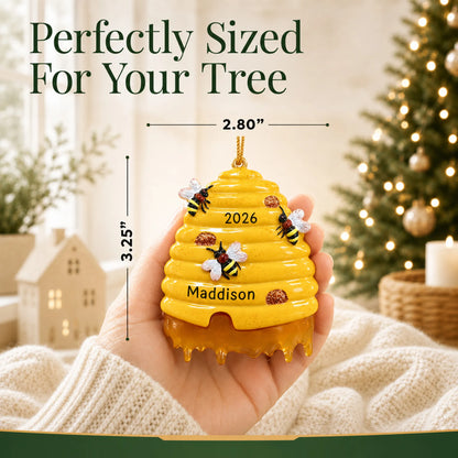Size guide: the personalized honey beehive christmas ornament is 2.80 in wide by 3.25 in tall, shown in hand