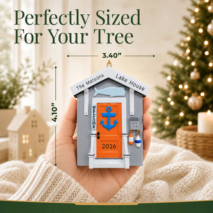 Size guide: the personalized Lake House christmas ornament is 3.40 in wide by 4.10 in tall, shown in hand