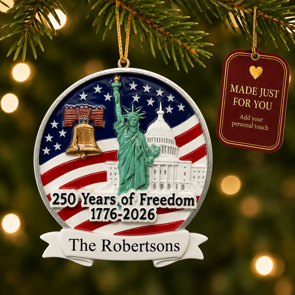 Personalized USA 250 Years of Freedom Christmas ornament hanging among tree lights with a Made Just For You tag