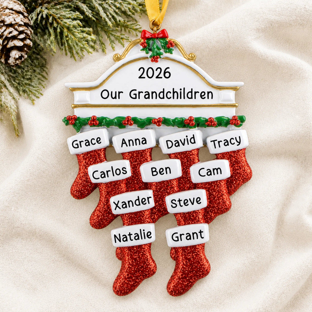 Personalized red stockings family of 11 christmas ornament laid on a soft white knit blanket
