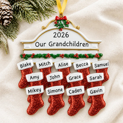 Personalized red stockings family of 13 christmas ornament laid on a soft white knit blanket