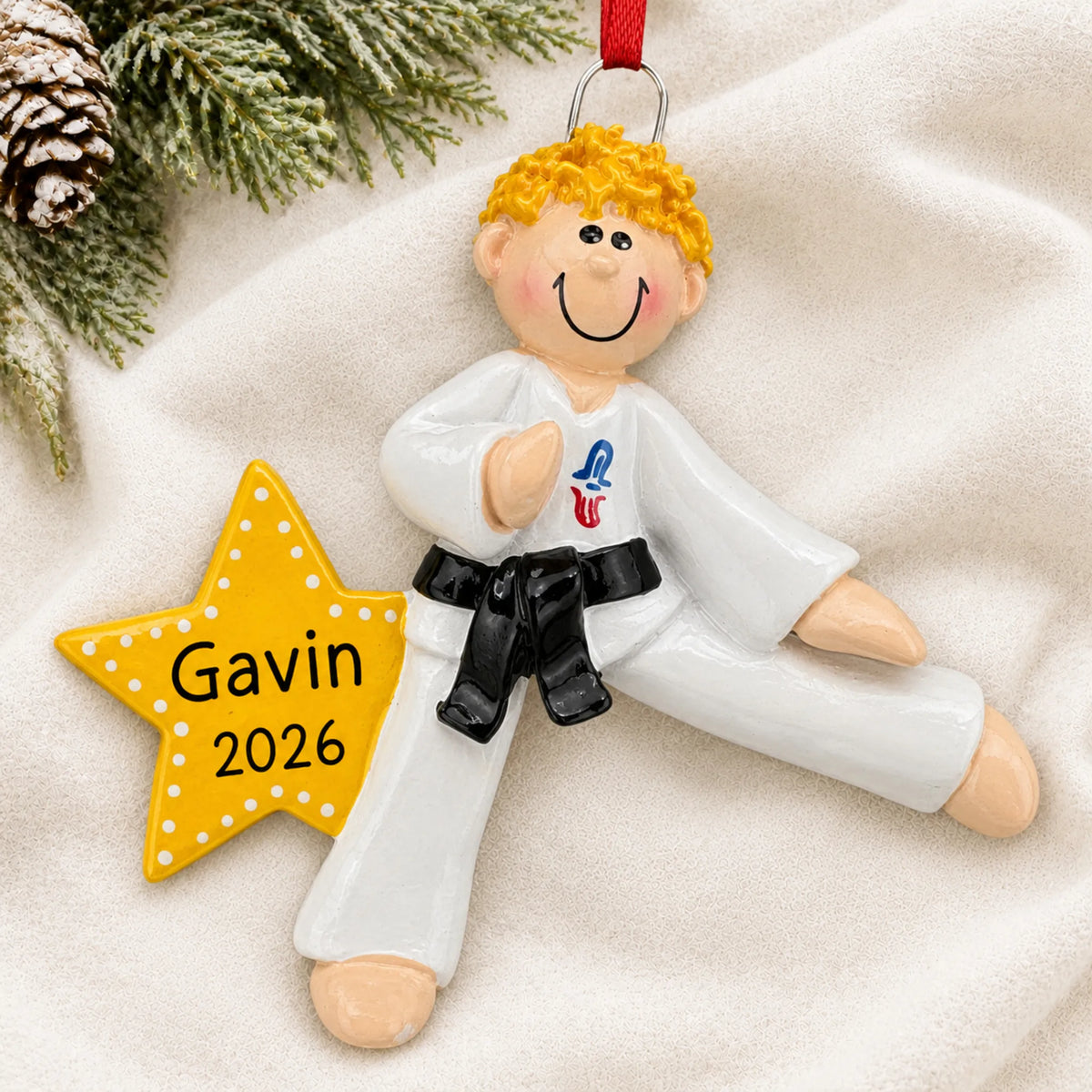 Personalized blonde karate MMA guy christmas ornament laid on a soft white knit blanket