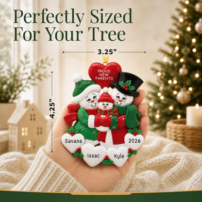 Size guide: the personalized new parents snowman christmas ornament is 3.25 in wide by 4.25 in tall, shown in hand