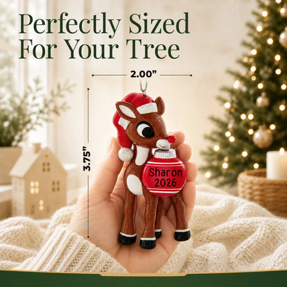 Size guide: the personalized Rudolph the Red-Nosed Reindeer christmas ornament is 2.00 in wide by 3.75 in tall, shown in hand