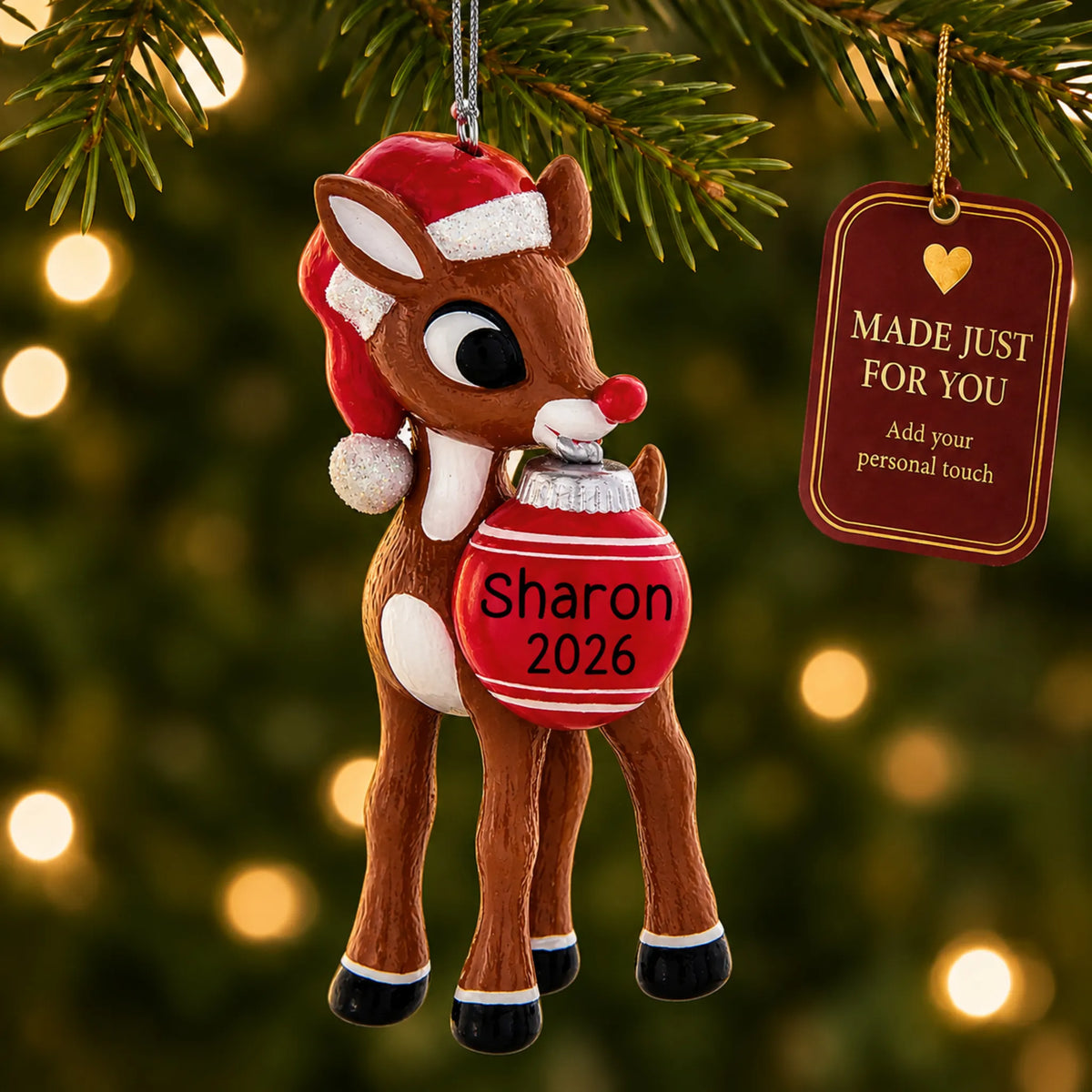 Rudolph the Red-Nosed Reindeer christmas ornament hanging on a lit Christmas tree with a Made Just For You gift tag