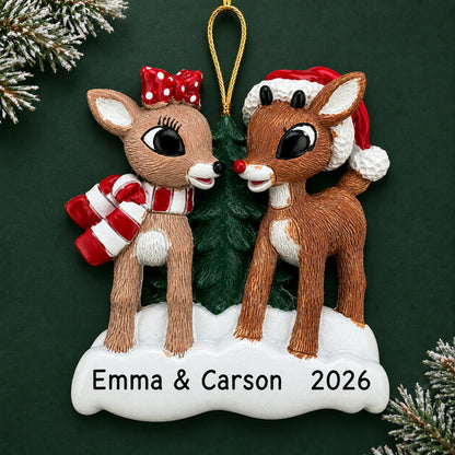 Personalized Rudolph and Clarice christmas ornament on a dark green pine background