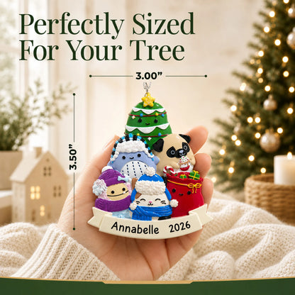 Size guide: the personalized Squishmallows christmas ornament shown in hand next to a Christmas tree