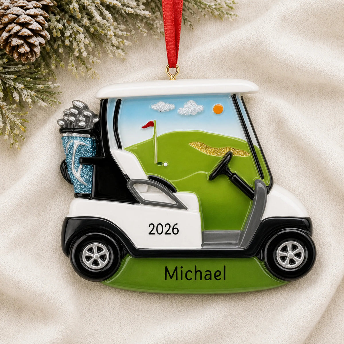 Personalized golf cart christmas ornament laid on a soft white knit blanket