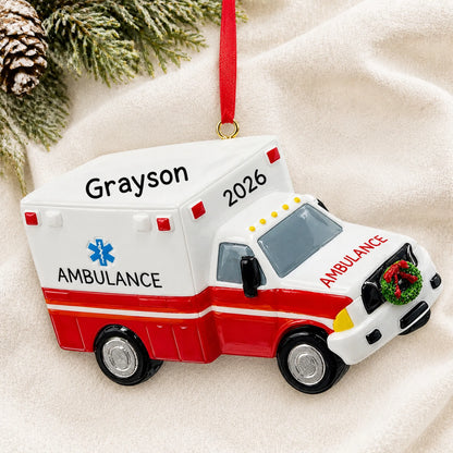 Personalized paramedic ambulance christmas ornament laid on a soft white knit blanket