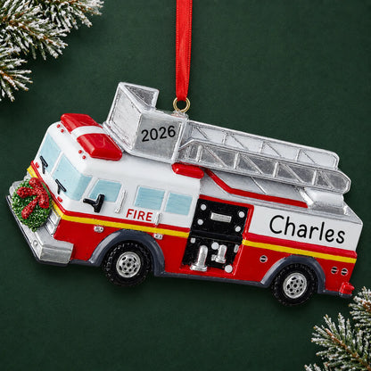 Personalized fire truck with ladder christmas ornament on a dark green pine background