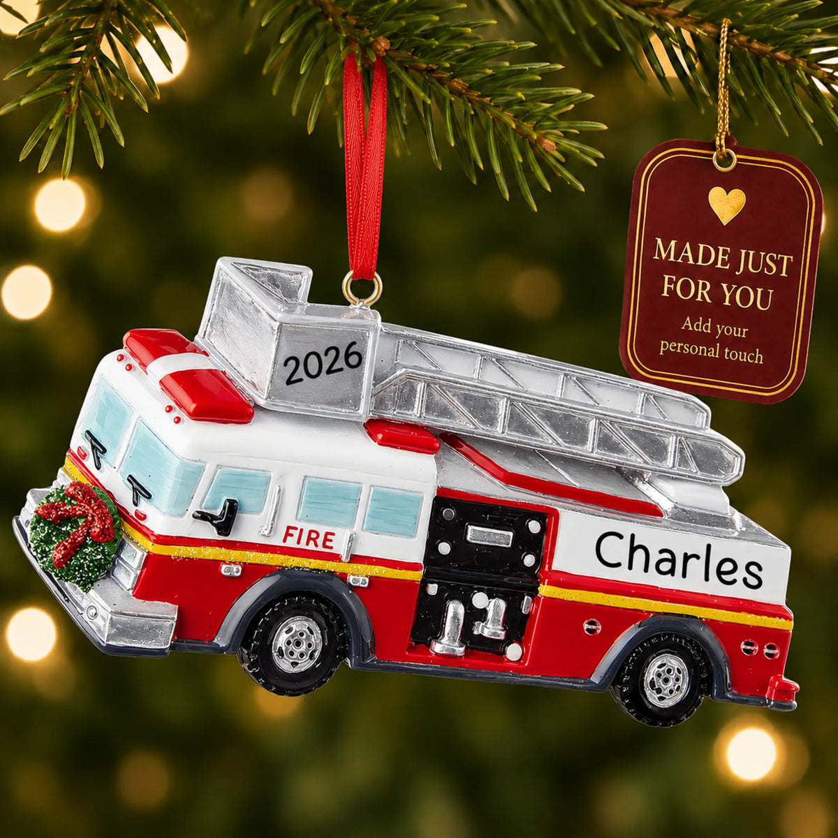 Fire truck with ladder christmas ornament hanging on a lit Christmas tree with a Made Just For You gift tag