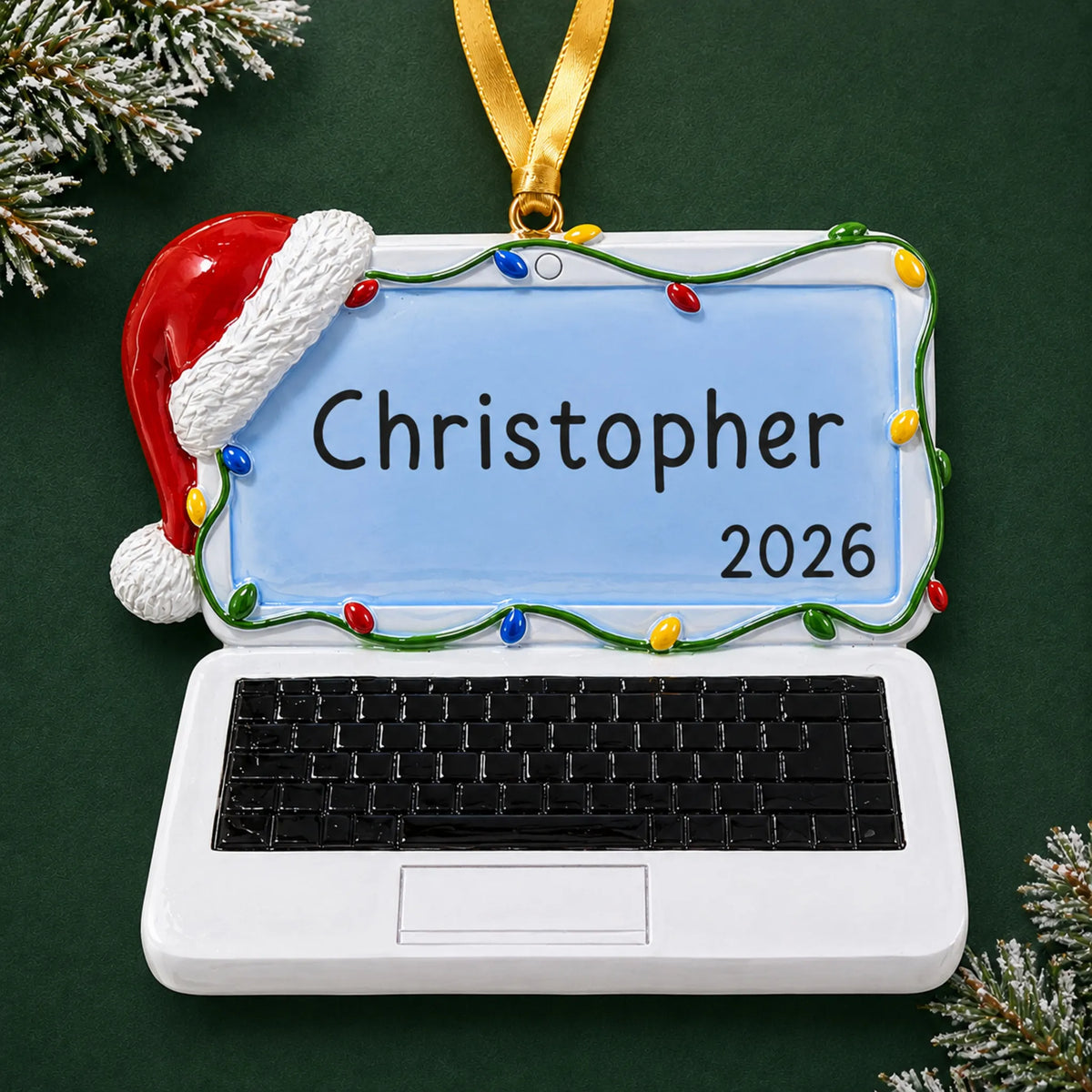 Personalized laptop computer christmas ornament on a dark green pine background
