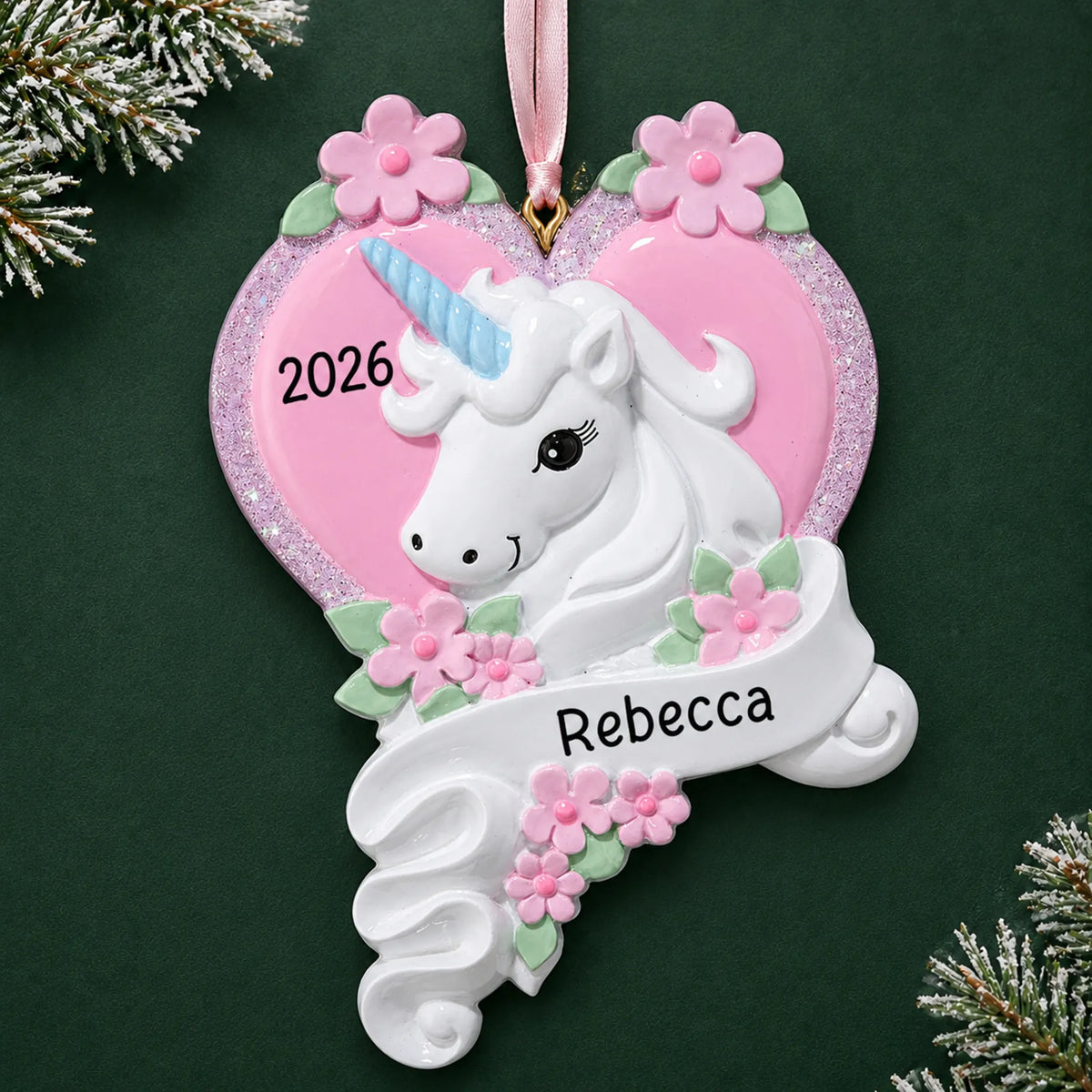 Personalized unicorn heart christmas ornament on a dark green pine background