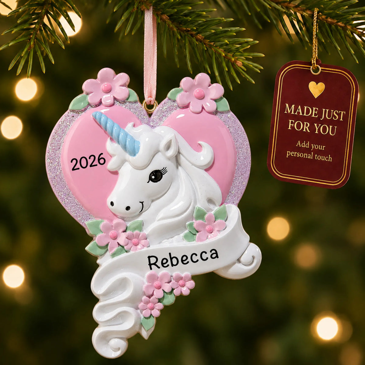 Unicorn heart christmas ornament hanging on a lit Christmas tree with a Made Just For You gift tag