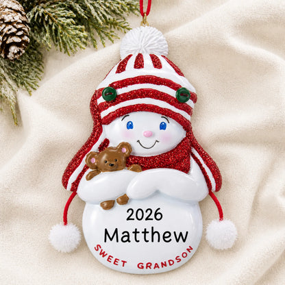 Personalized sweet grandson christmas ornament laid on a soft white knit blanket