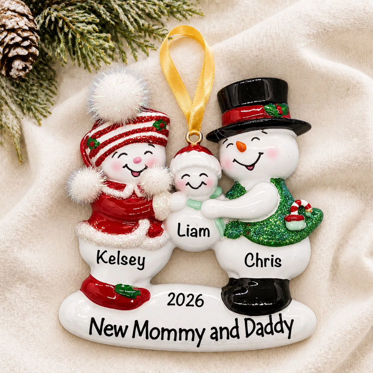 Personalized new parents 1st christmas ornament laid on a soft white knit blanket