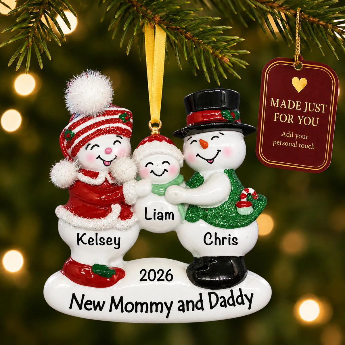 New parents 1st christmas ornament hanging on a lit Christmas tree with a Made Just For You gift tag