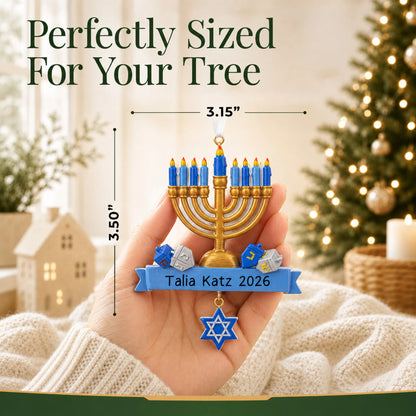 Size guide: the personalized Hanukkah Menorah christmas ornament is 3.15 in wide by 3.50 in tall, shown in hand