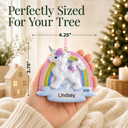Size guide: the personalized unicorn rainbow christmas ornament shown in hand next to a Christmas tree