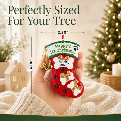 Size guide: the personalized Puppy's First Christmas Stocking ornament is 2.50 in wide by 4.00 in tall, shown in hand