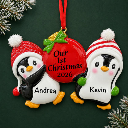 Personalized our first christmas penguins ornament on a dark green pine background