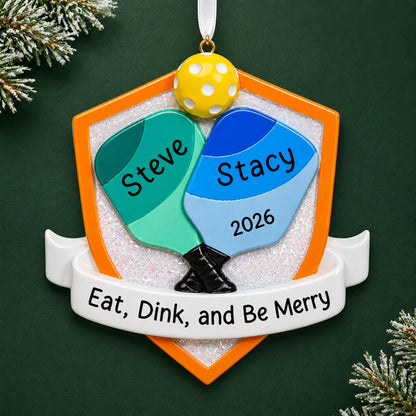 Personalized pickleball doubles christmas ornament on a dark green pine background
