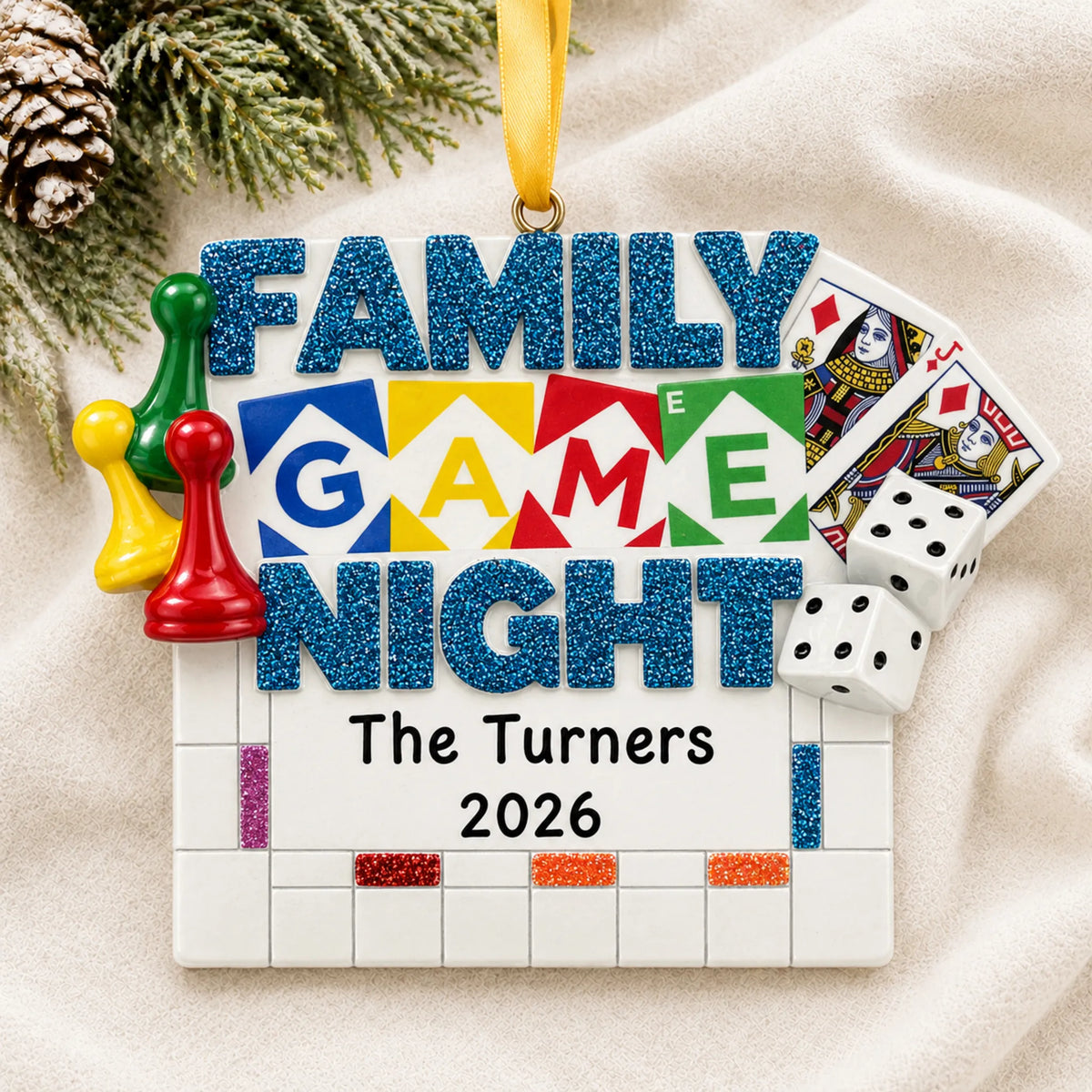 Personalized family game night christmas ornament laid on a soft white knit blanket