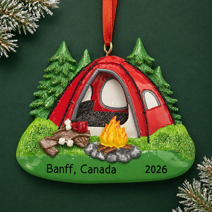 Personalized red camping tent christmas ornament on a dark green pine background
