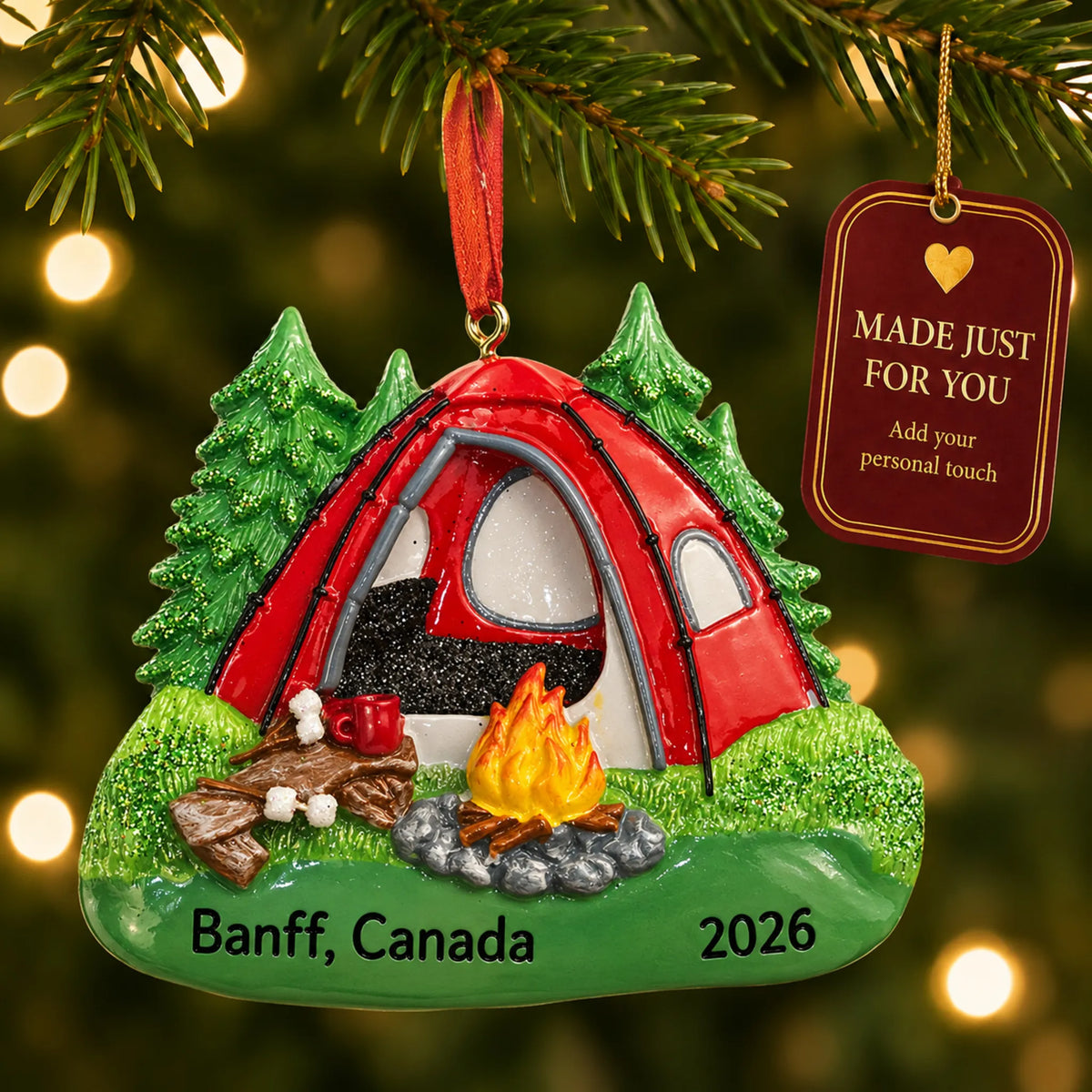 Red camping tent christmas ornament hanging on a lit Christmas tree with a Made Just For You gift tag