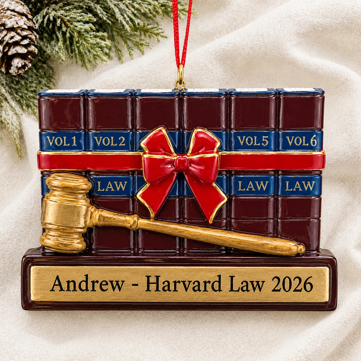 Personalized attorney law and gavel christmas ornament laid on a soft white knit blanket